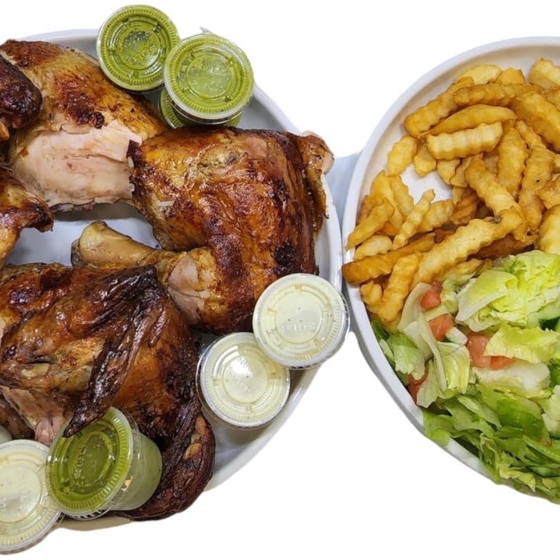 Tandoori Pollo a la Brasa's roasted chicken, fries, and salad with various sauces.