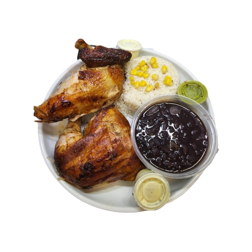 Tandoori Pollo a la Brasa meal with roasted chicken, rice, corn, black beans, and sauces.